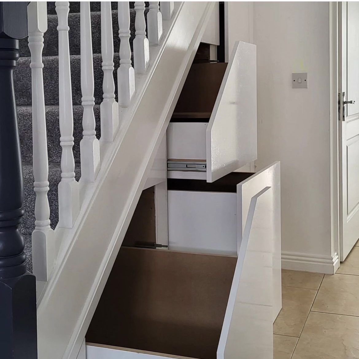 Pull-out drawers built in under a staircase